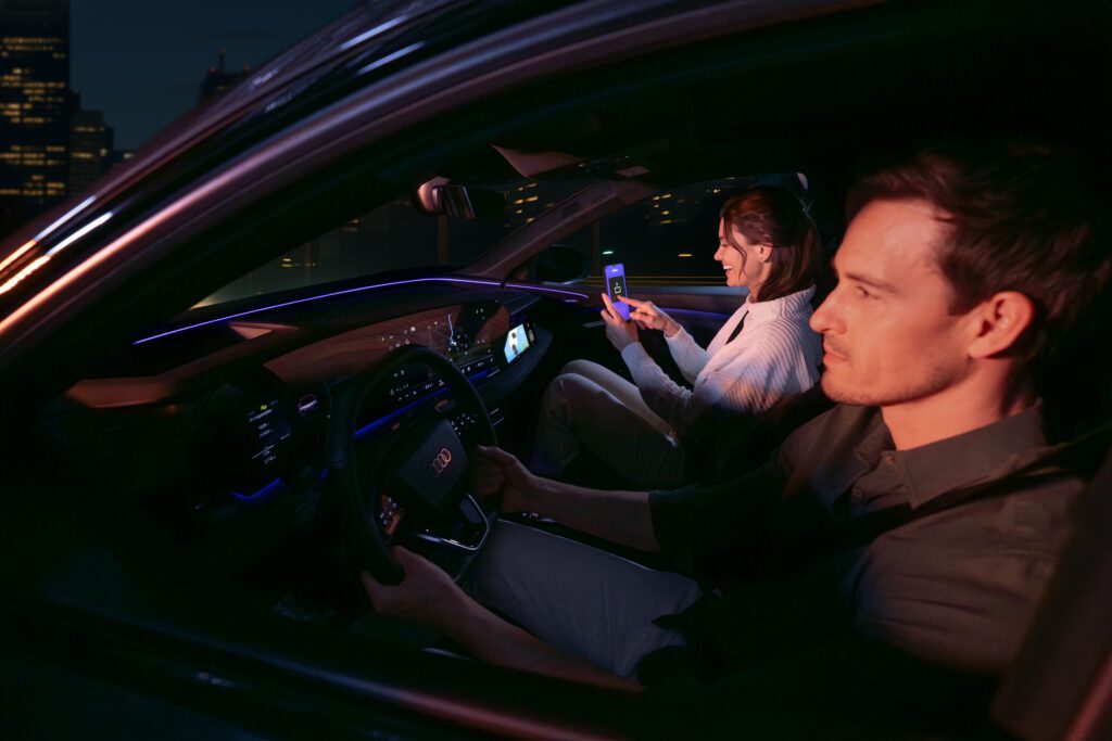 AirConsole and Audi Partnership: Passenger playing AirConsole while vehicle is in motion — front-seat display experience.jpg