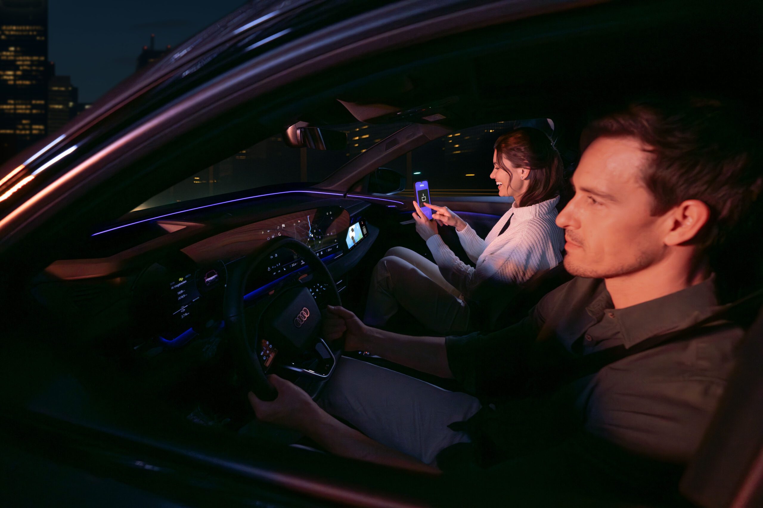 AirConsole and Audi Partnership: Passenger playing AirConsole while vehicle is in motion — front-seat display experience.jpg